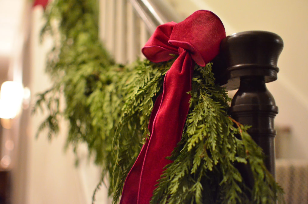 Red Bow and Greenery on Staircase Banister
