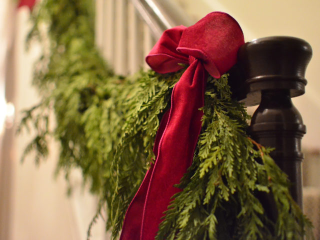 Red Bow and Greenery on Staircase Banister
